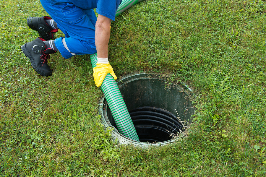 emptying household septic tank. cleaning sludge from septic system.